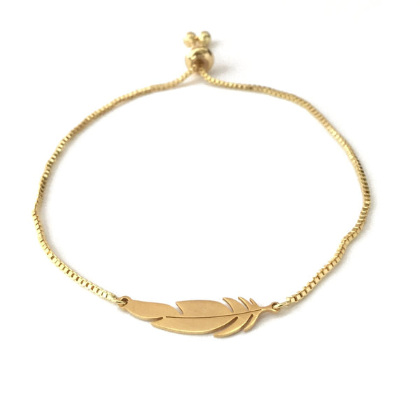 Gold stainless steel feather pendant on a gold stainless steel adjustable bracelet