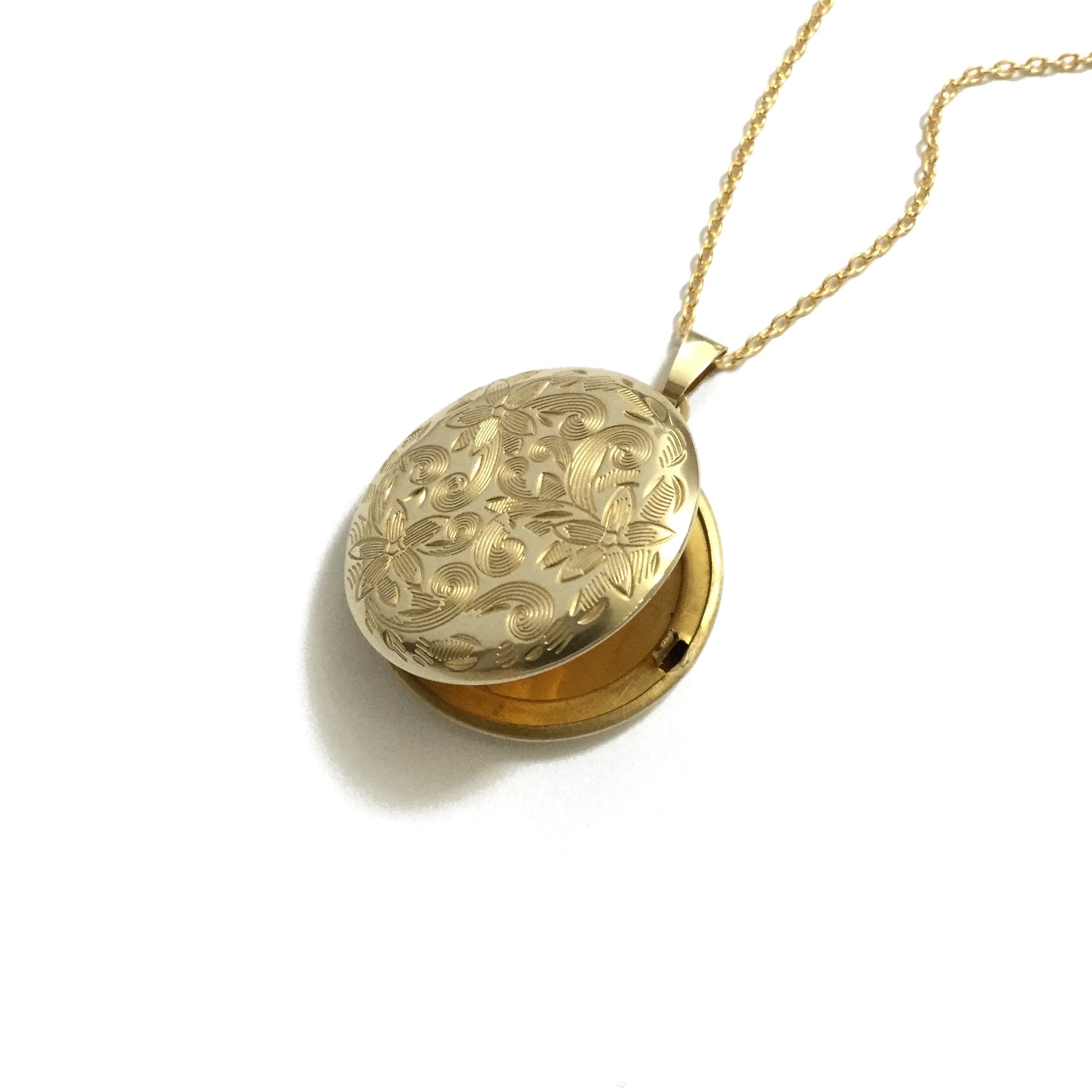 Gold plated shiny brass round floral locket